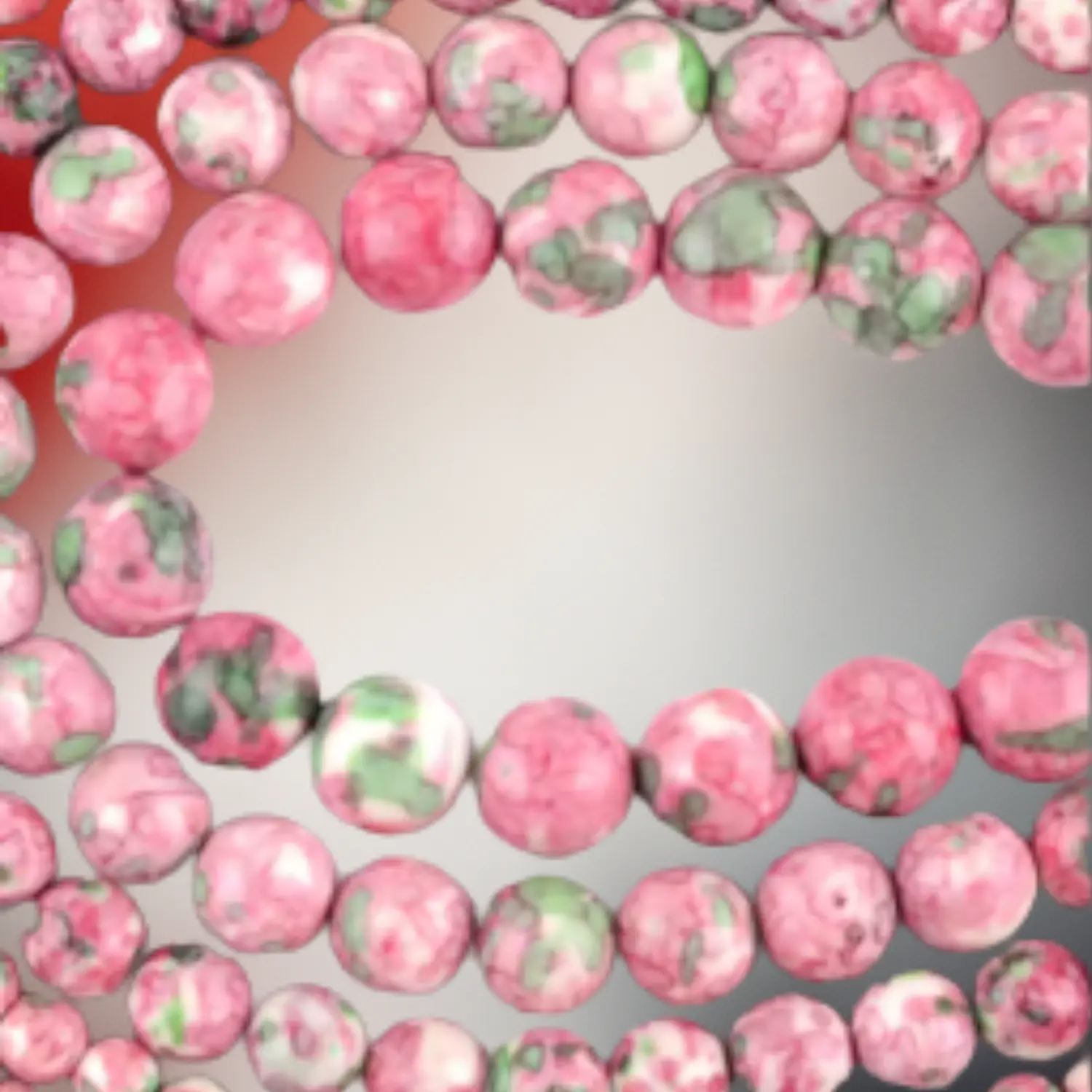 Perles de jaspe impérial teint aux nuances rose et vert, utilisées pour des bijoux en macramé artisanaux Fil Dé Toile